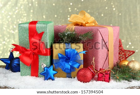 Beautiful bright gifts and christmas decor, on shiny background