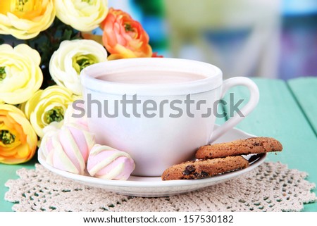 Cocoa drink on wooden  table, on bright background