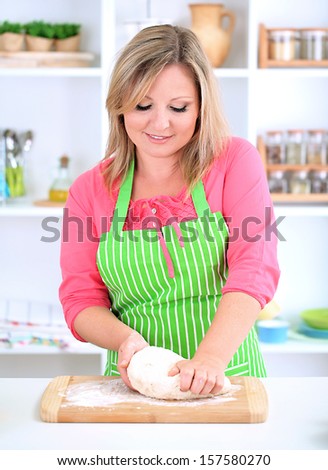 Woman kneads dough