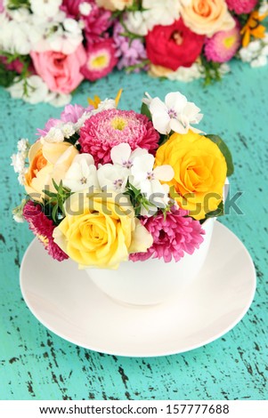 Beautiful bouquet of bright flowers in color vase,  on bright background