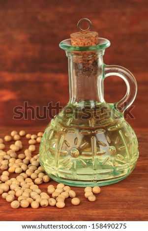 Soy beans and oil on wooden background