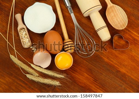 Cooking concept. Basic baking ingredients and kitchen tools on wooden table