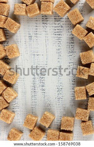 Brown sugar on wooden background