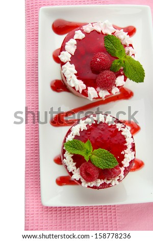 Delicious berry cakes on plate close-up