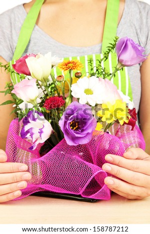 Florist makes flowers bouquet