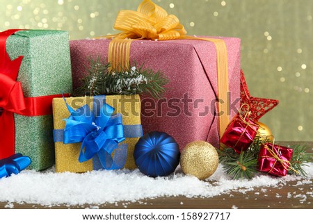 Beautiful bright gifts and christmas decor, on shiny background
