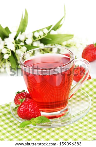 Delicious strawberry tea on table on white background