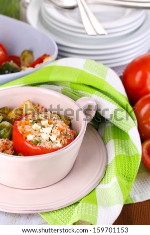 Stuffed tomatoes in pan on wooden table close-up