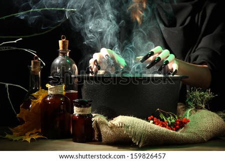 Witch in scary Halloween laboratory on dark color background