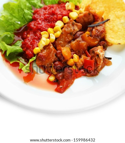 Chili Corn Carne - traditional mexican food, on white plate, on napkin, isolated on white