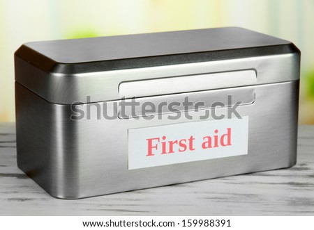 First aid box on bright background