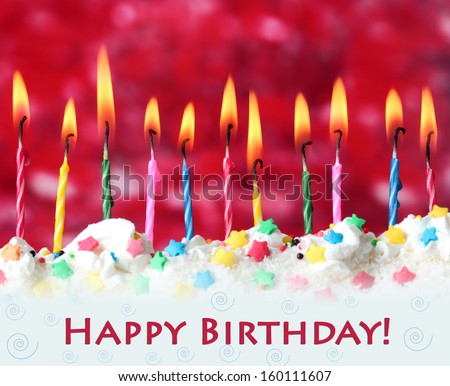 Beautiful birthday candles  on red background