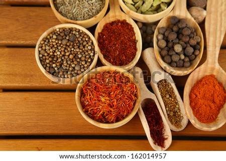 Many different spices and fragrant herbs on wooden table close-up