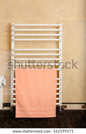 Color towel on  radiator in bathroom