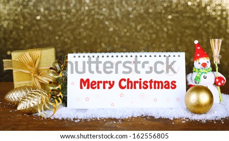 Empty calendar, New Year decor and fir tree on shiny golden background