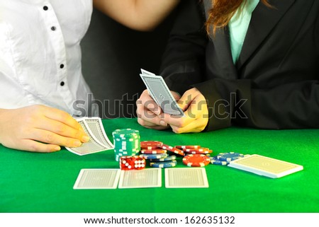 People playing cards at table