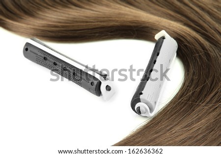 Shiny brown hair with curler isolated on white