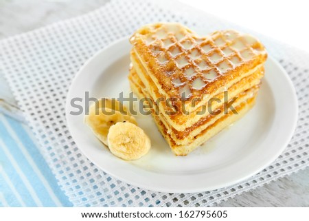 Sweet Belgium waffles with banana, isolated on white