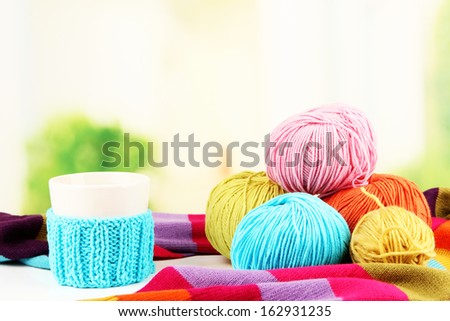 Multicolored clews with cup and bright scarf closeup