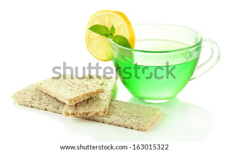 Transparent cup of green tea and diet bread isolated on white
