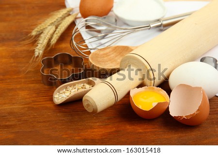 Cooking concept. Basic baking ingredients and kitchen tools on wooden table