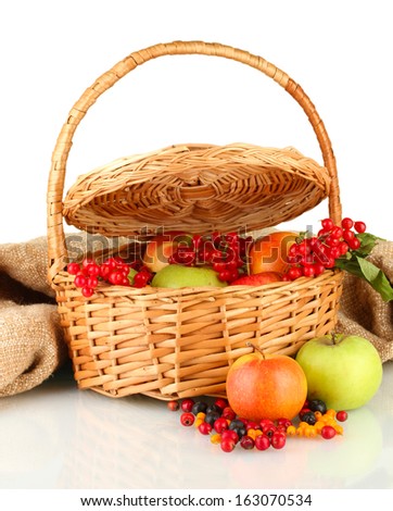 crop of berries and fruits in a basket on white background close-up