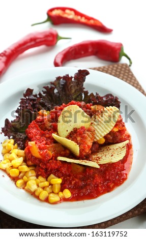 Chili Corn Carne - traditional mexican food, on white plate, on napkin, isolated on white