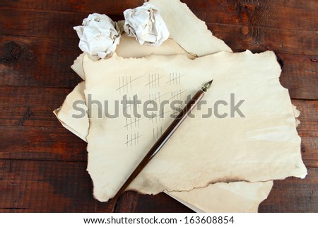 Counting days by drawing sticks on paper on wooden background