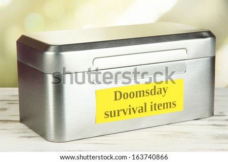 Silver box with survival items on bright background