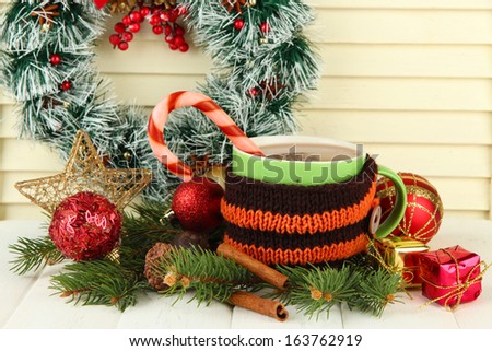 Cup of hot cacao with Christmas decorations on table on wooden background