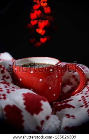 Cup of coffee with plaid on dark background