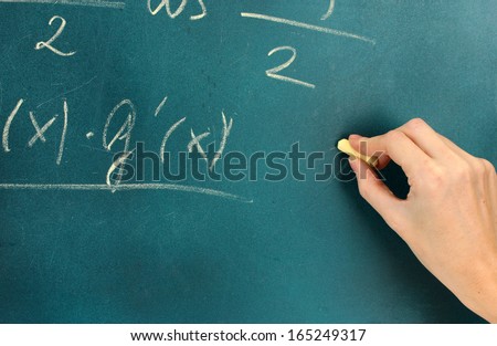 Math formula written on blackboard with chalk.