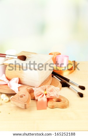 Handmade wooden box and art materials for decor, on table