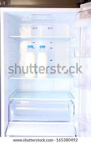 Bottles with milk in refrigerator