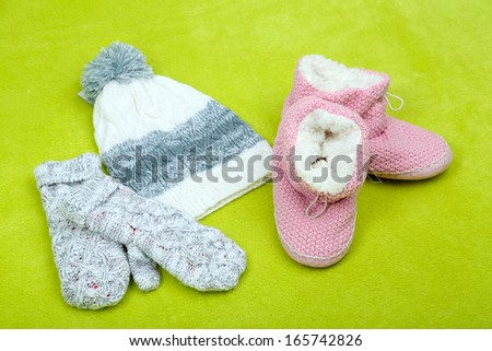 Winter cap, shoes and gloves,  on color background