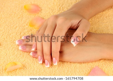 woman\'s hands on yellow terry towel, close-up