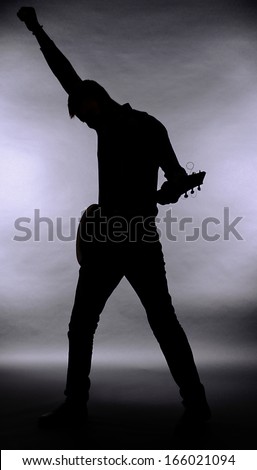 Guitarist silhouette on dark gray background