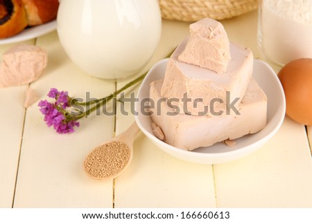 Dry yeast with pastry and baking ingredients on wooden table close-up