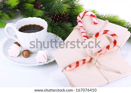 Christmas candy canes, cup with hot drink and letters for Santa, isolated on white