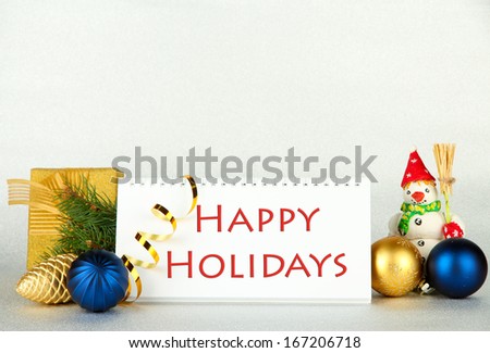 Calendar with greeting, New Year decor and fir tree on light background