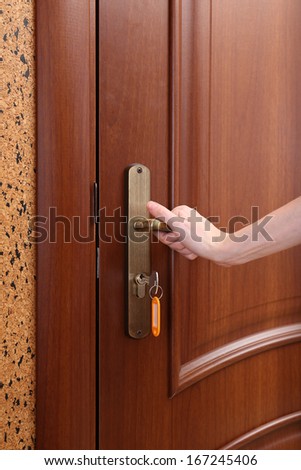 Locking up or unlocking door with key in hand