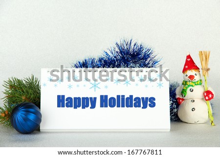 Calendar with greeting, New Year decor and fir tree on light background