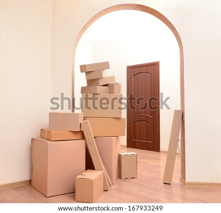 Empty room with stack of cartons: moving house concept