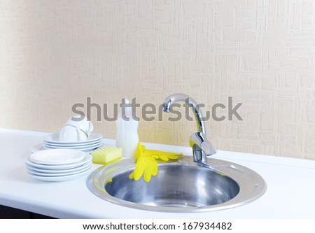 Dishes drying near  metal sink