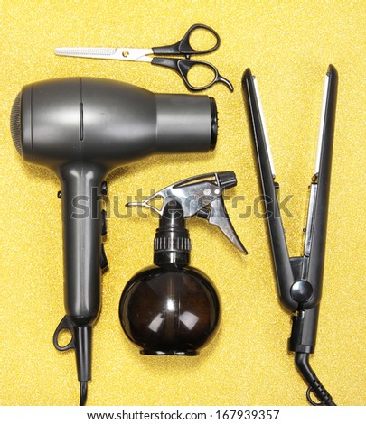 Hairdressing tools on golden background