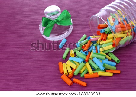 Dreams written on color  rolled paper in glass jar, on color background