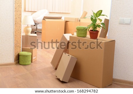 Empty Room With Stack Of Cartons: Moving House Concept