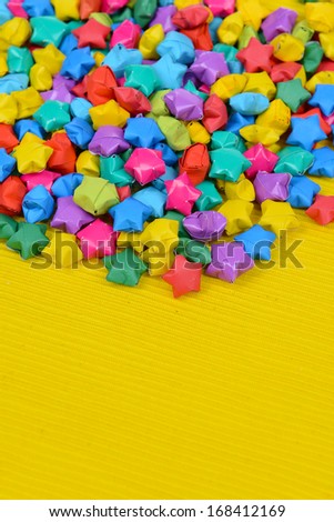 Paper stars with dreams on yellow background