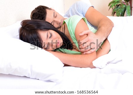 Couple in love sleeping in bed
