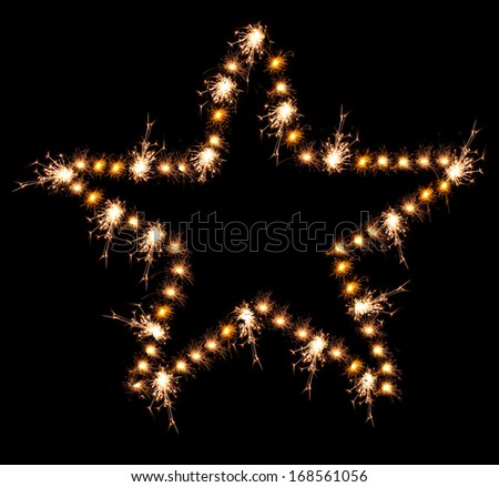 Christmas sparklers in shape of star on black background